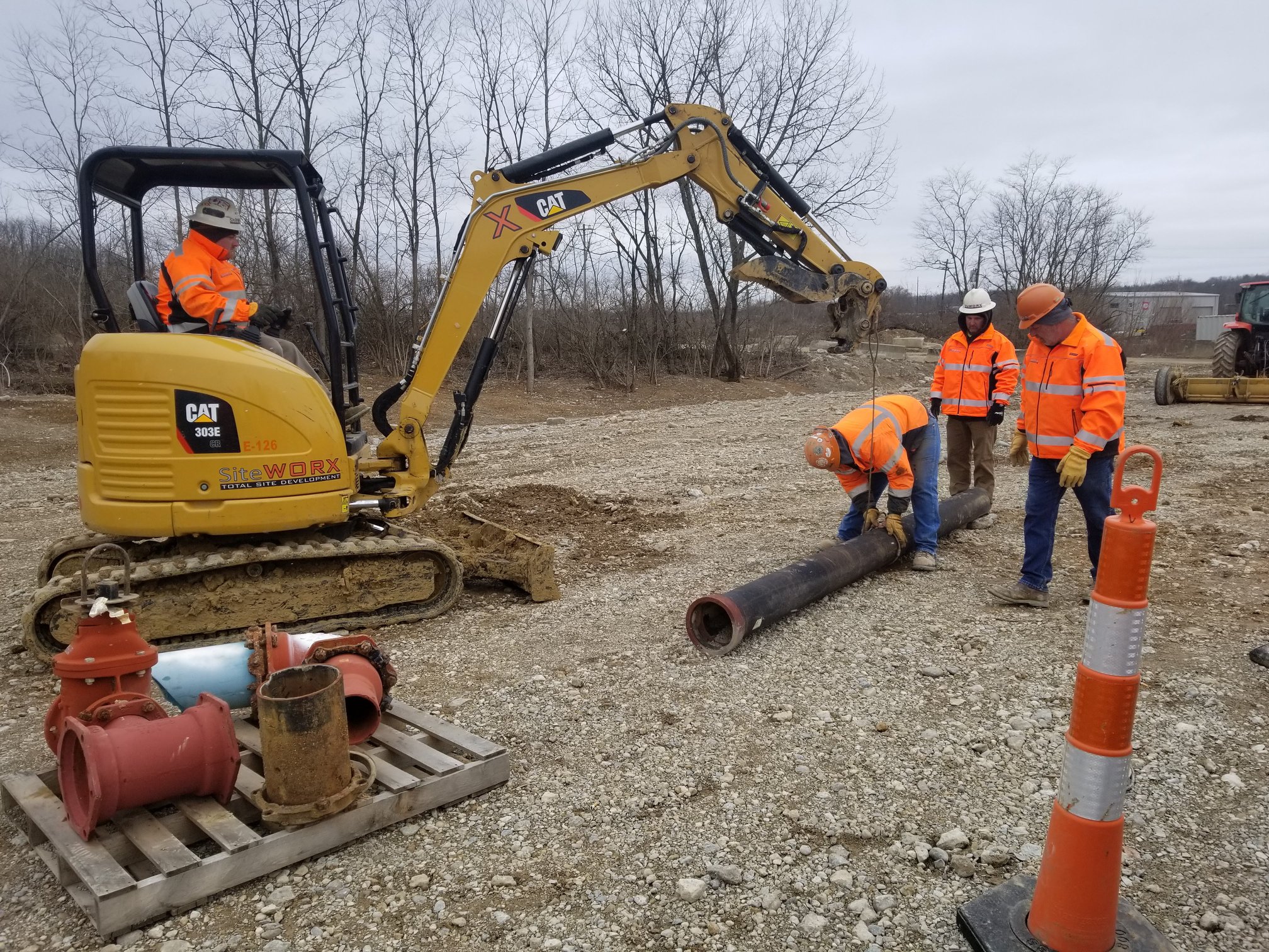 contruction workers moving around a pole